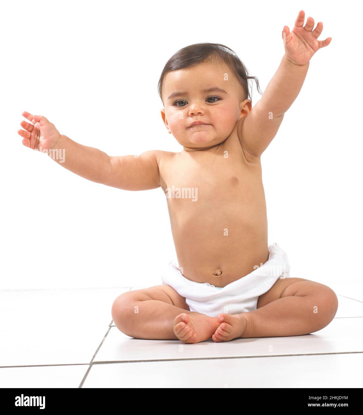 Baby girl sitting wearing nappy Stock Photo Alamy
