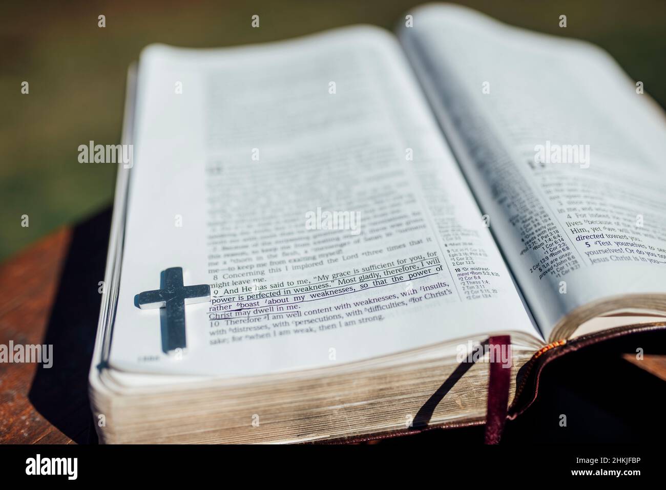 Close up view of Bible verse with metal cross Stock Photo