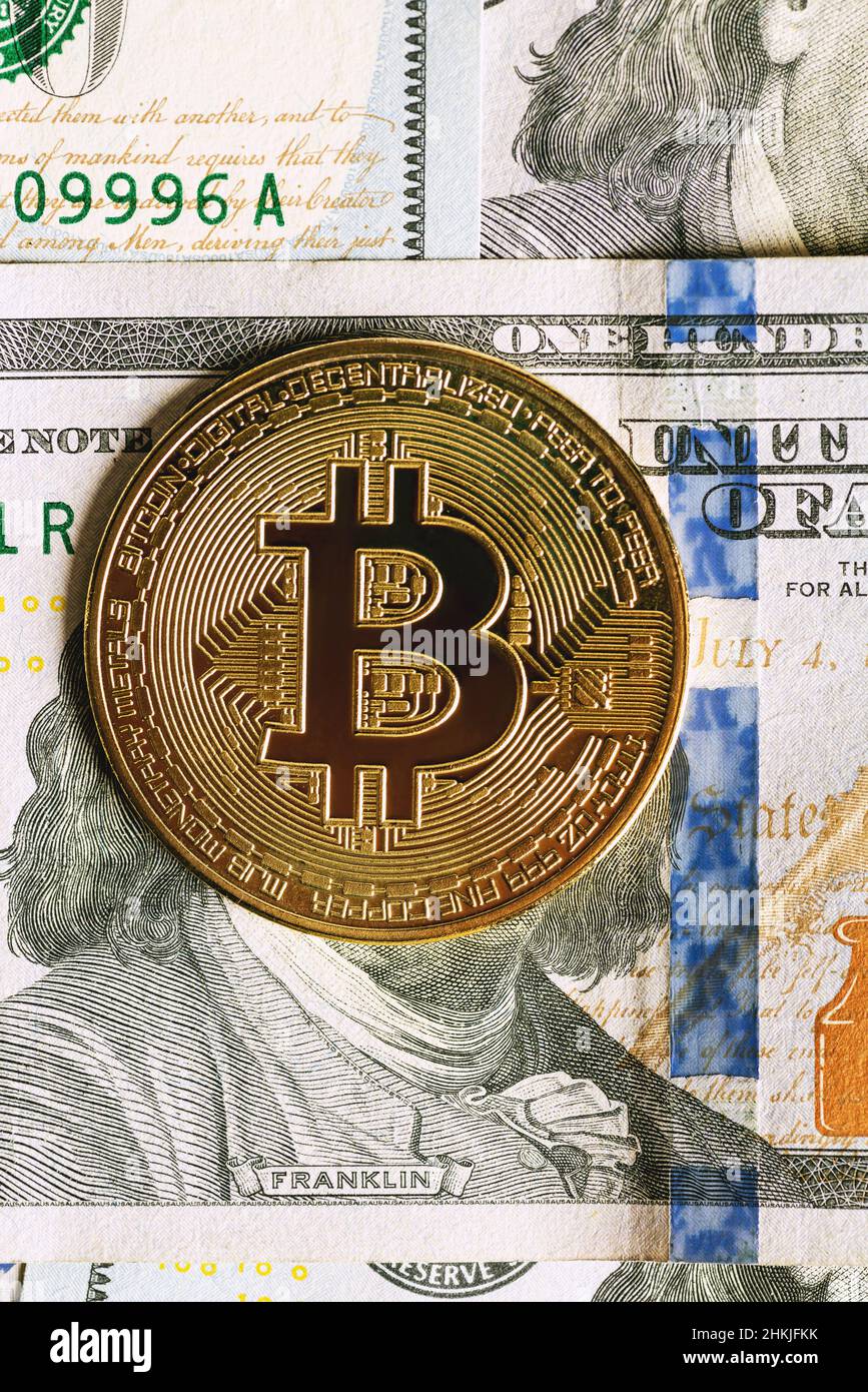 Bitcoin on 100 dollar bill background, gold coin of bitcoin on a hundred  dollar bill. Earnings on cryptocurrency mining Stock Photo - Alamy