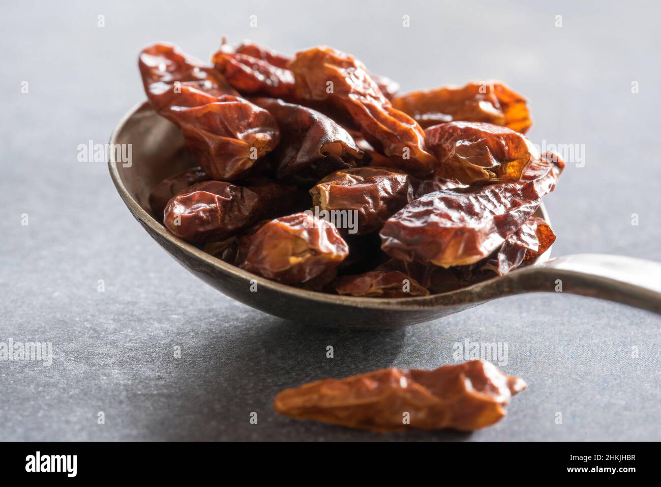 Dried Bird's Eye Peppers on a Vintage Spoon Stock Photo