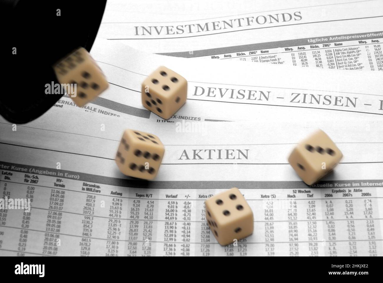 dices falling over the business section of a newspaper, Germany Stock Photo
