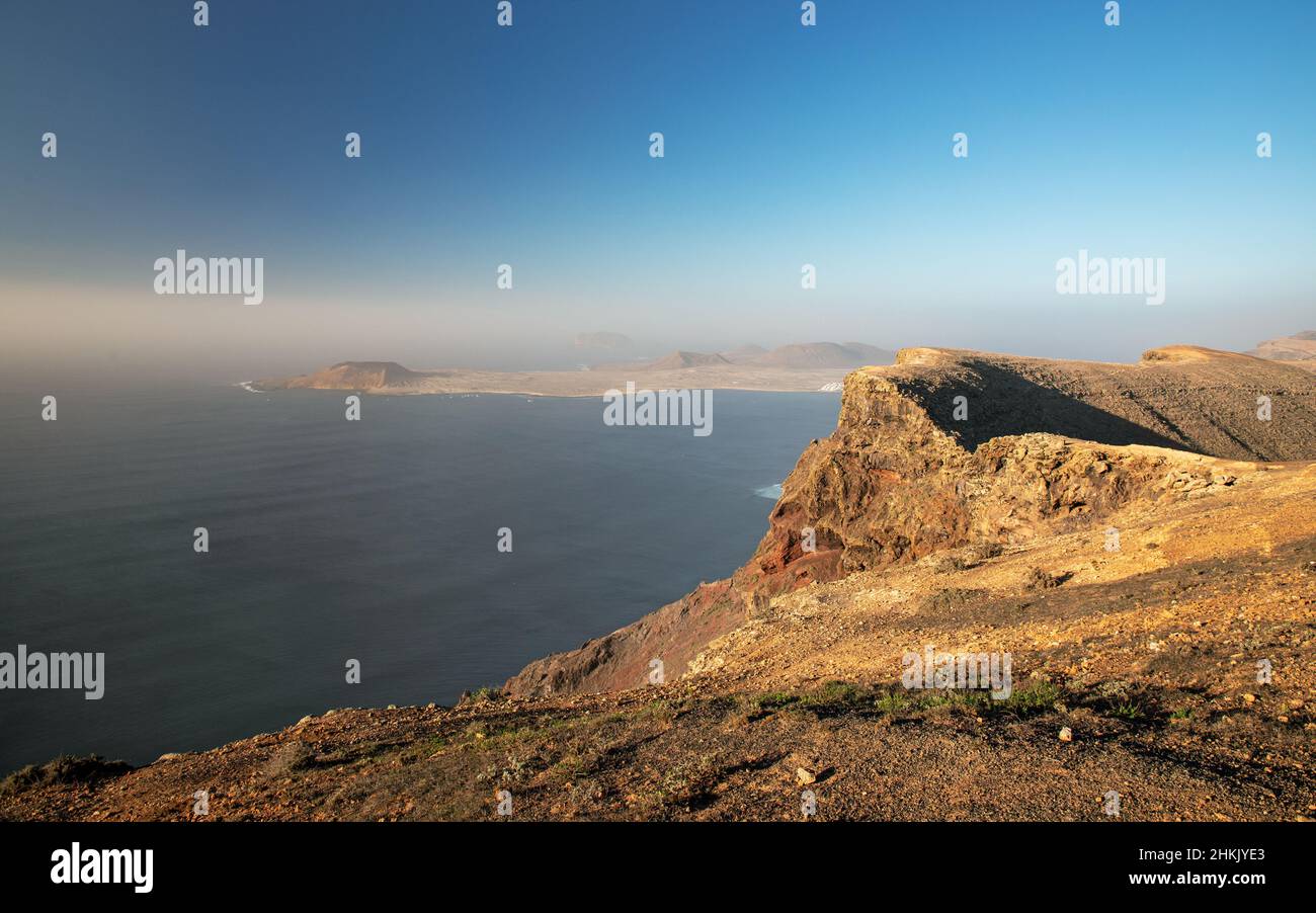 view from Mirador Los Helechos to Risco de Famara and La Graciosa island, Canary Islands, Lanzarote, Maguez Stock Photo