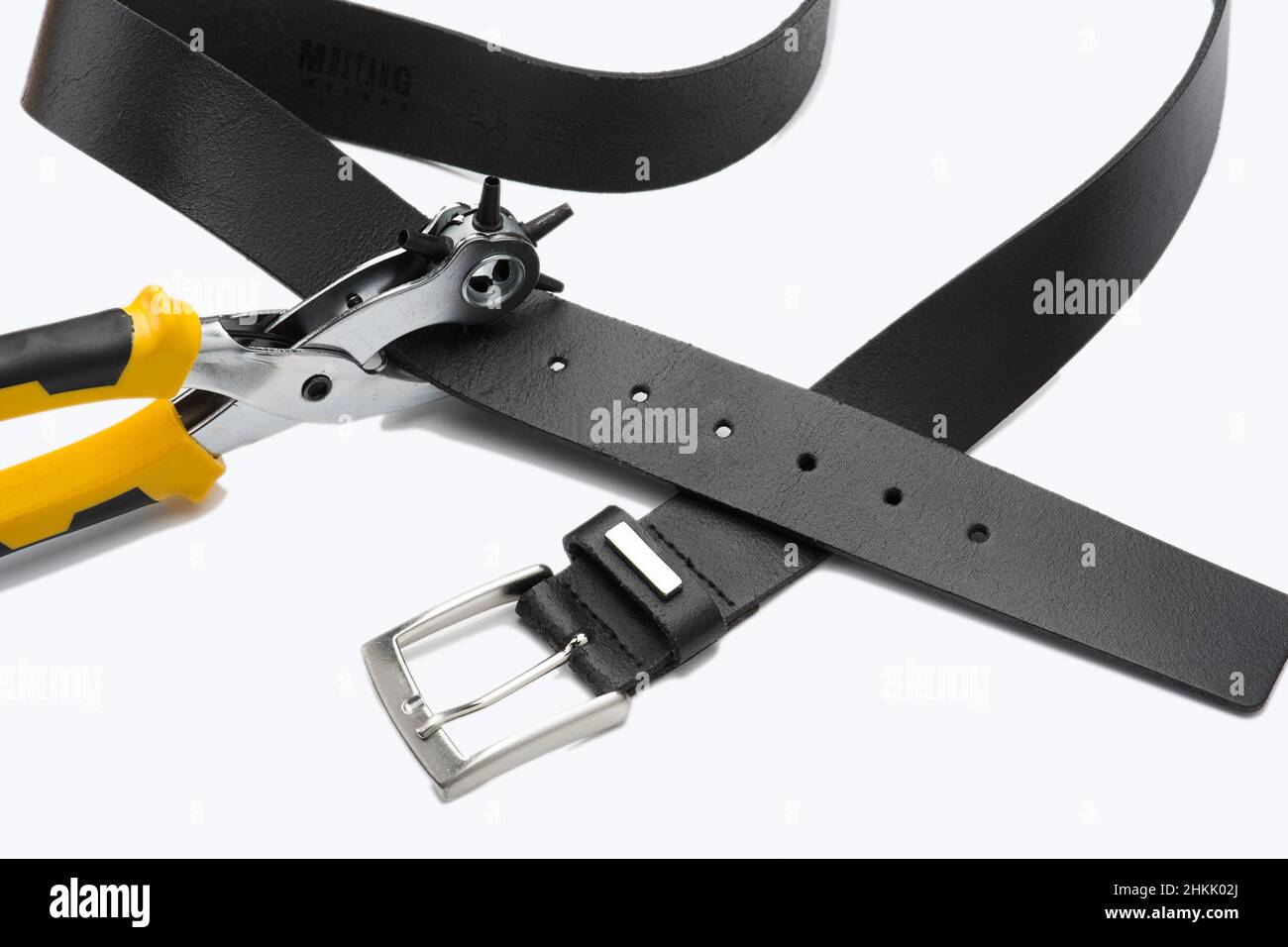 black leather belt with punch, cutout Stock Photo