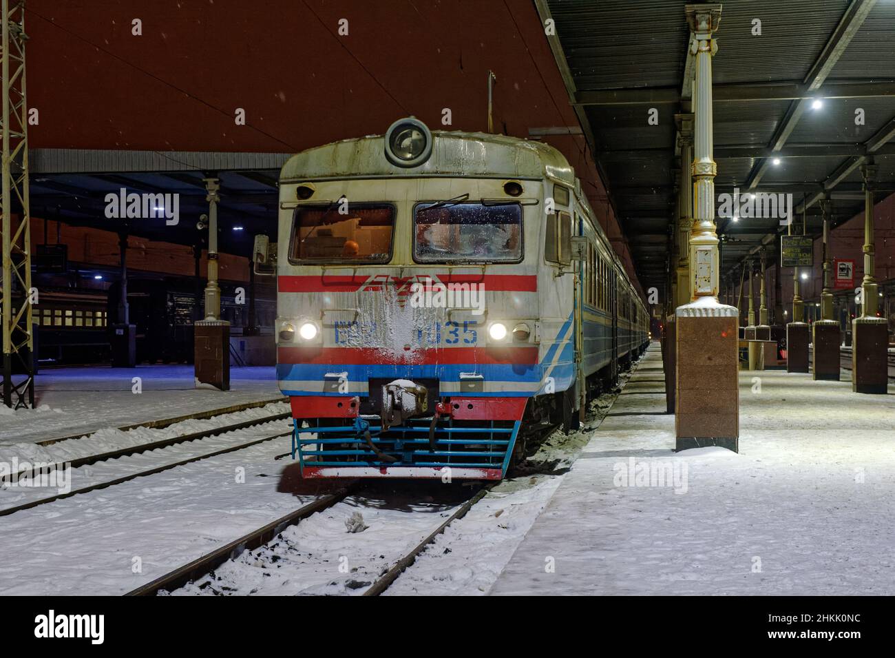 Kharkiv, Ukraine - January 28, 2022: Old electric train of Ukrainian Railways stand near the station platform in Kharkiv Passenger Railway Station. Ni Stock Photo