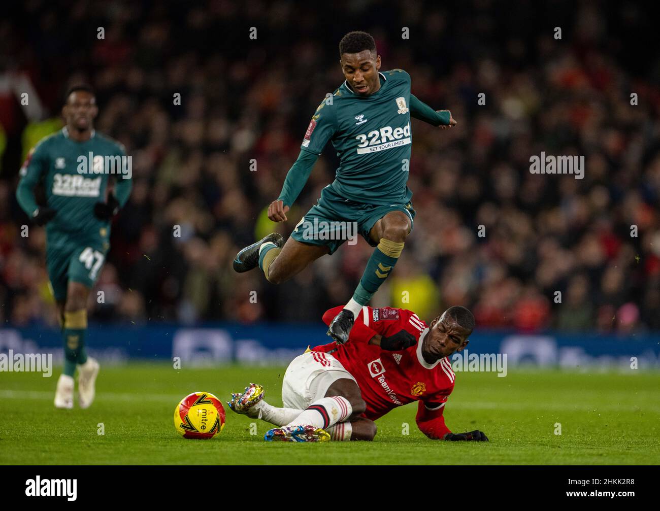 Manchester, UK. 5th Feb, 2022. Middlesbrough's Isaiah Jones (top) is tackled by Manchester United's Paul Pogba during the English FA Cup fourth round match between Manchester United and Middlesbrough in Manchester, Britain, Feb. 4, 2022. Credit: Xinhua/Alamy Live News Stock Photo