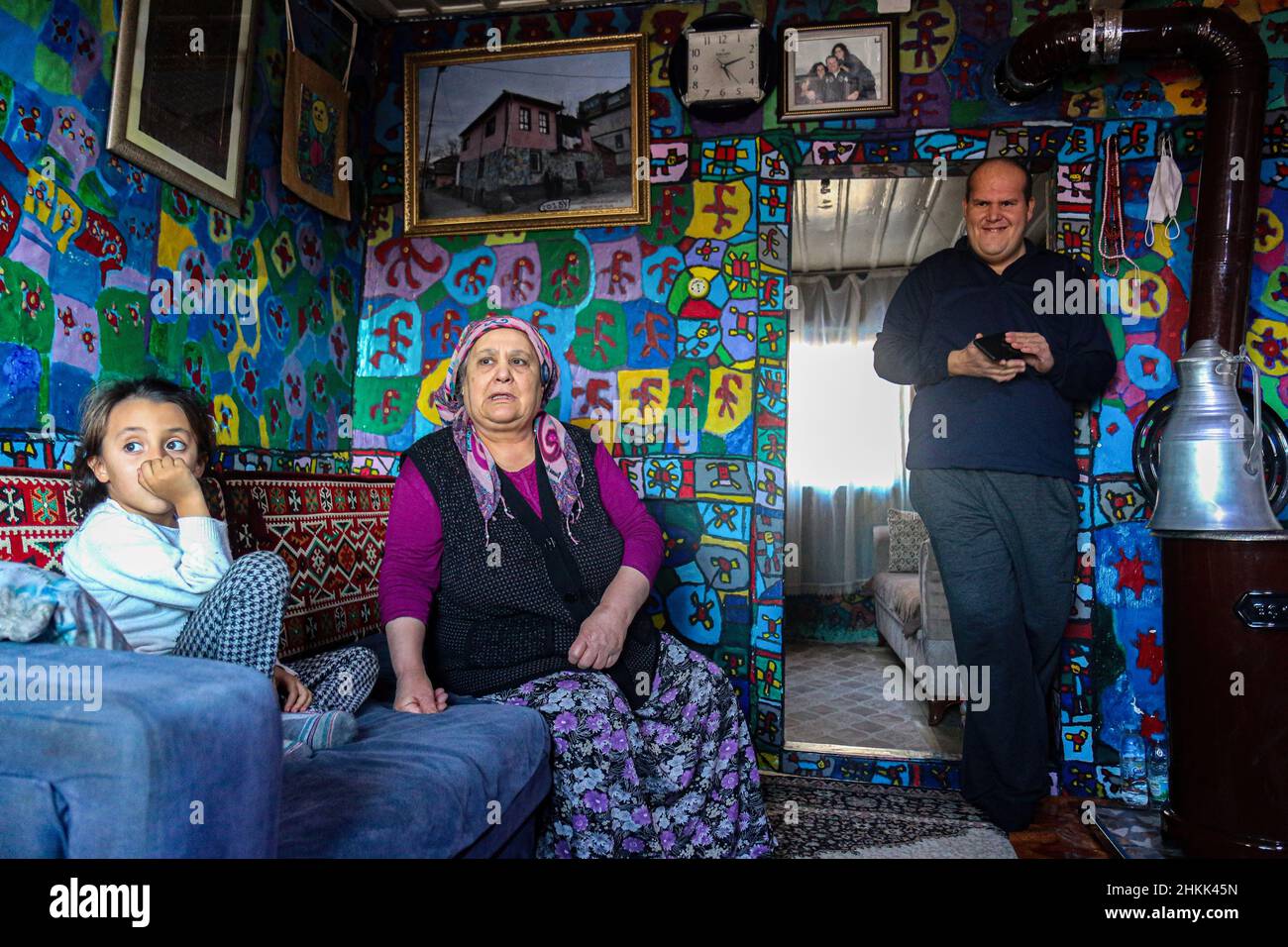 Ankara, Turkey. 04th Feb, 2022. Muhammed is seen with his niece and mother.Muhammed Yalç?n, who is mentally handicapped painter, lives in Ankara, Turkey. He went to a special education school of handicapped for 2 months in 2009. This is the time he discovered his passion and he lives with his family in their shanty house and has painted the whole house as a canvas to express his imagination. Credit: SOPA Images Limited/Alamy Live News Stock Photo