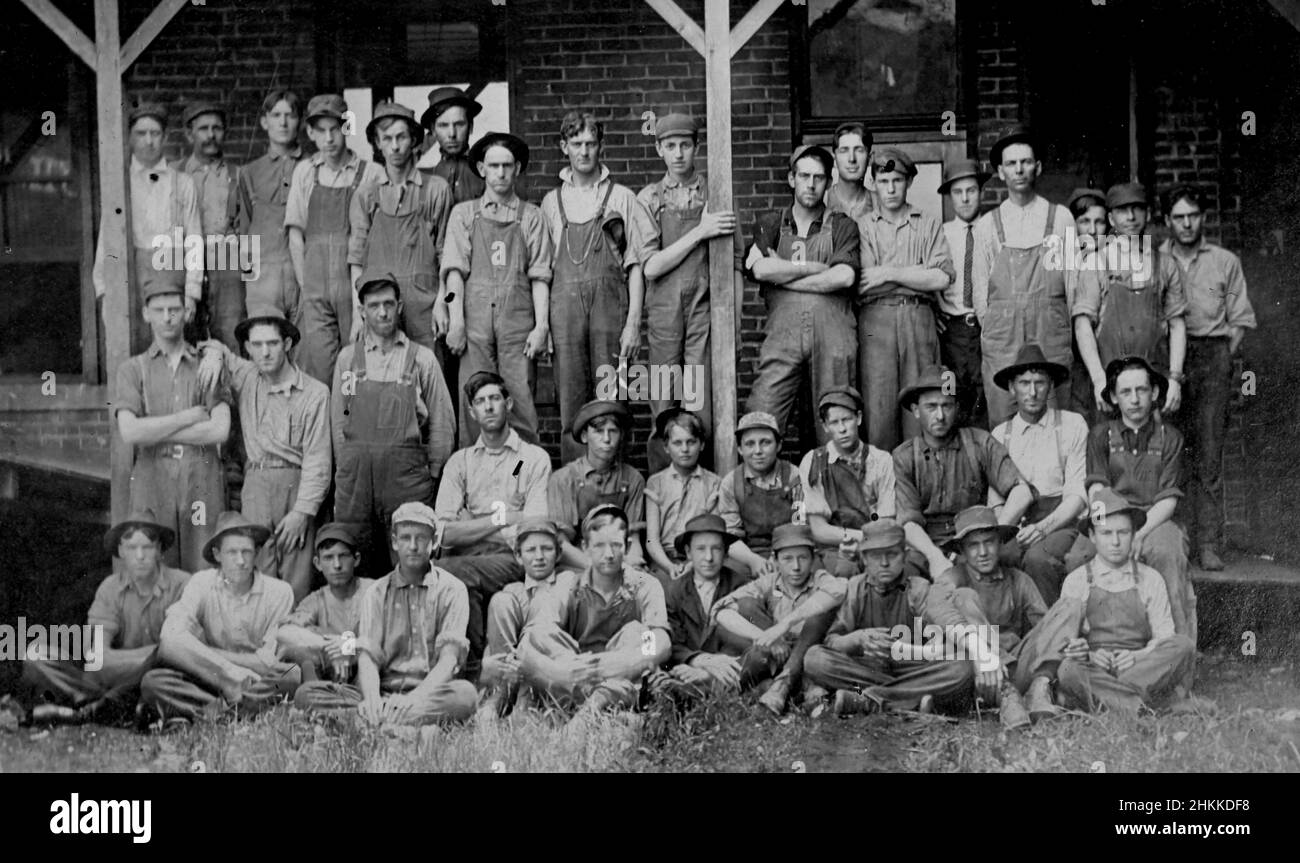 Men and boys pose in front of a machine shop in Pennsylvania, ca. 1930