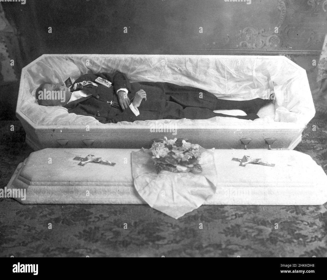 A deceased teenage boy is laid out in his coffin, ca. 1927. Stock Photo