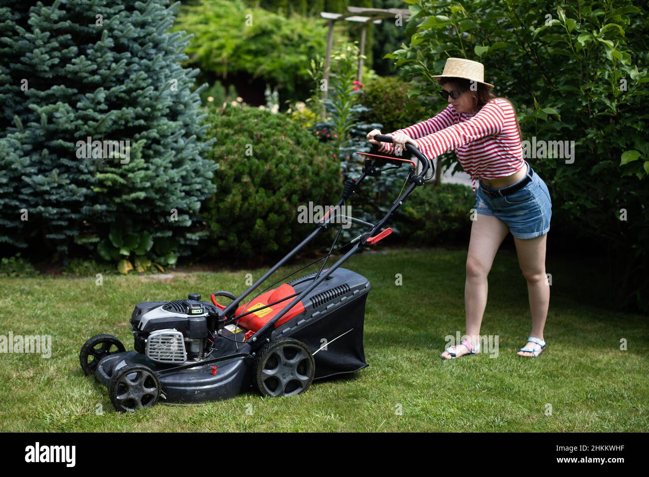 Woman cutting grass with a lawn mower hi-res stock photography and images -  Alamy