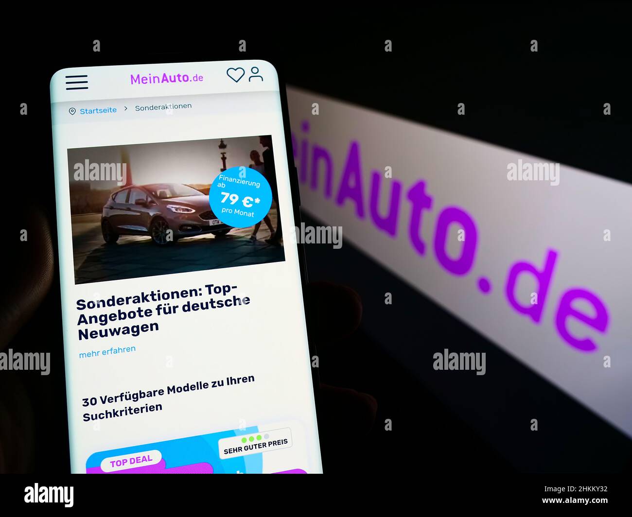 Person holding cellphone with website of German online car dealing company  MeinAuto GmbH on screen with logo. Focus on center of phone display Stock  Photo - Alamy
