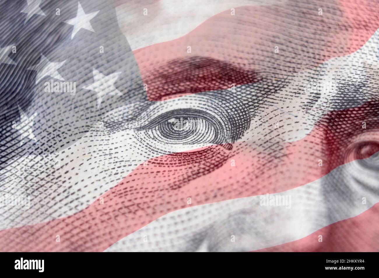 United states hundred dollars money bill. Benjamin Franklin on american flag background. Hundred dollar bill close-up fragment Stock Photo
