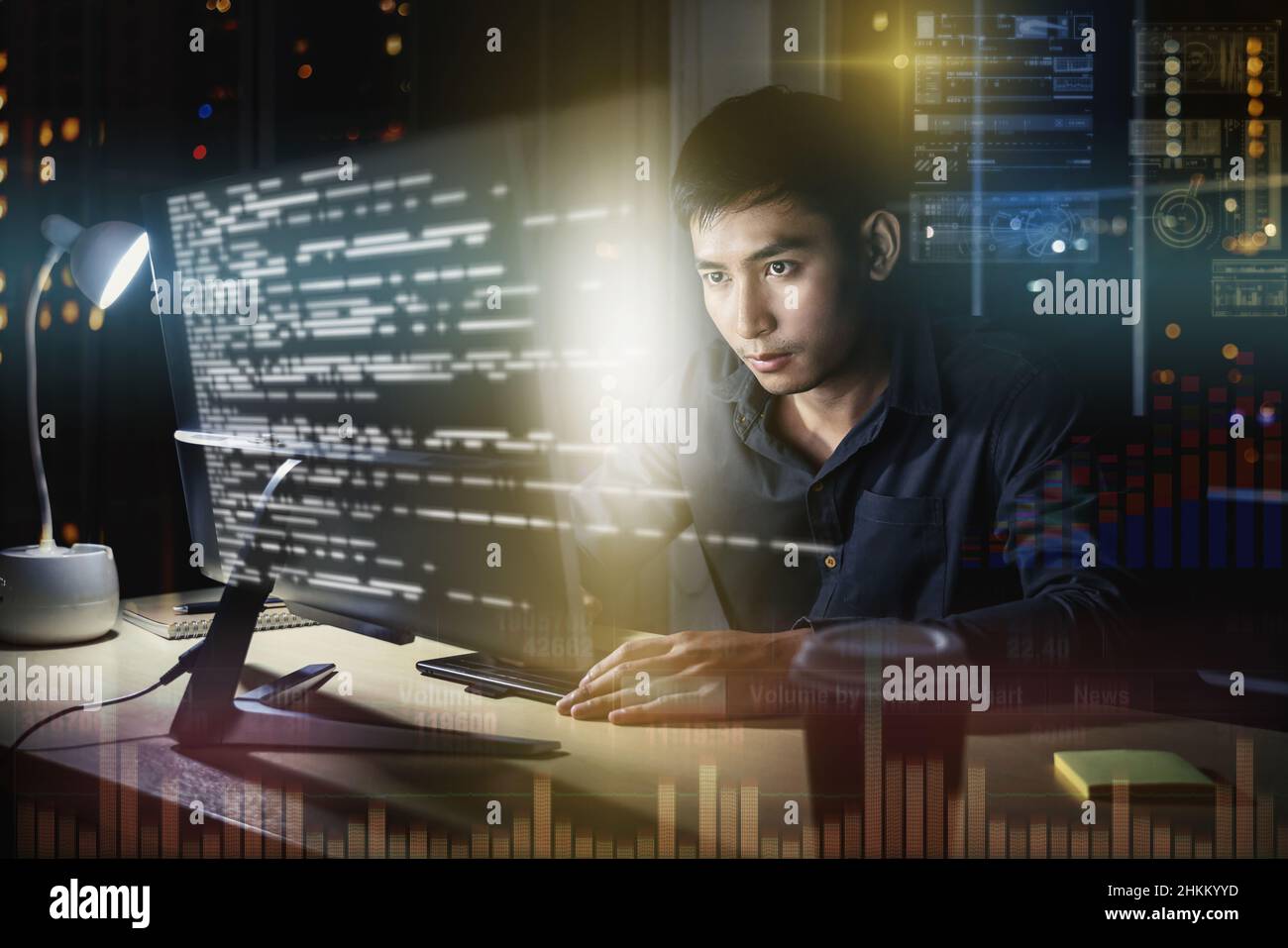 Asian Businessman working hard late with his technology computer in ...