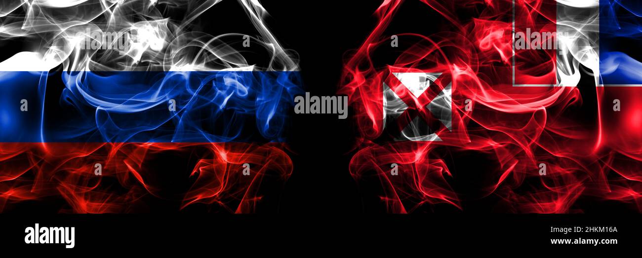 Russia, Russian vs France, French, Wallis and Futuna flags. Smoke flag placed side by side isolated on black background. Stock Photo