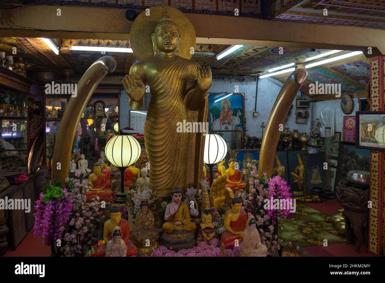 COLOMBO, SRI LANKA - FEBRUARY 22, 2020: Ancient sculpture of standing Buddha in one of the premises of Gangaramaya Temple Stock Photo