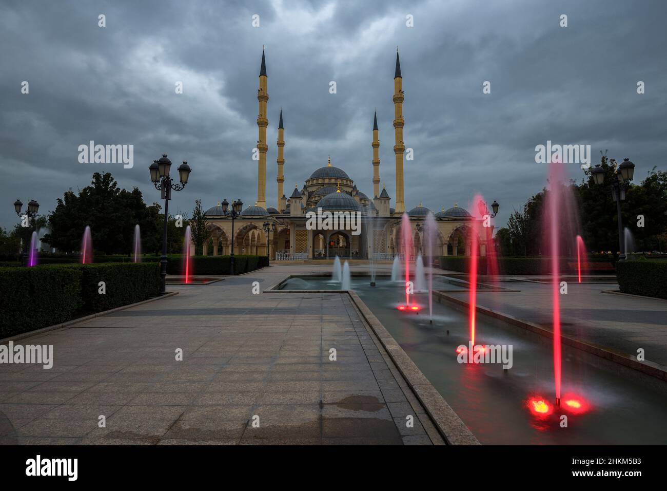 GROZNY, RUSSIA - SEPTEMBER 29, 2021: City park with fountains at the Heart of Chechnya mosque on a September twilight Stock Photo