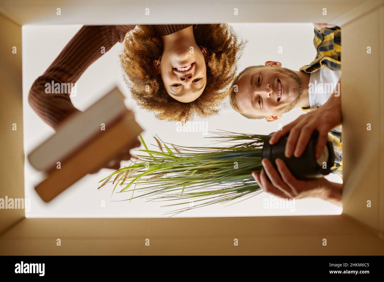 Couple packing boxes for move bottom view Stock Photo