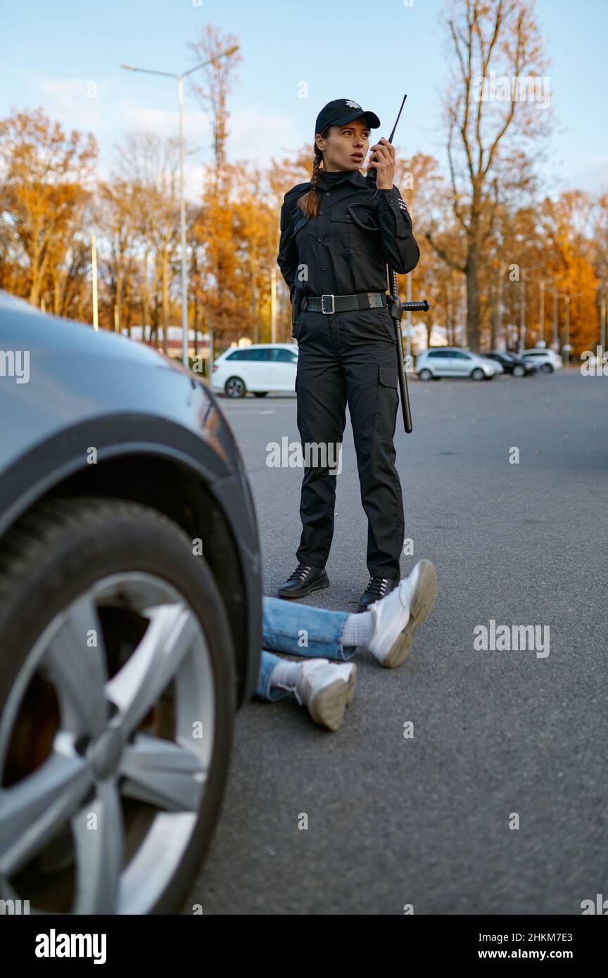 Police woman officer near car crash driver victim Stock Photo