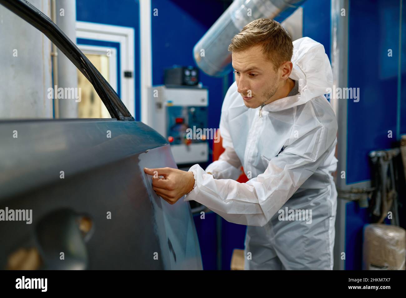Painter examining car body paint check process Stock Photo Alamy