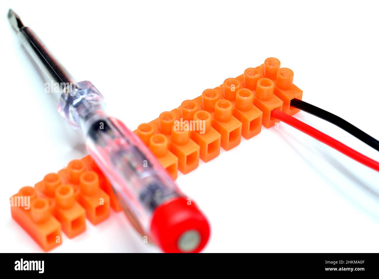terminal block with fixed plus and minus cables and screw driver Stock Photo