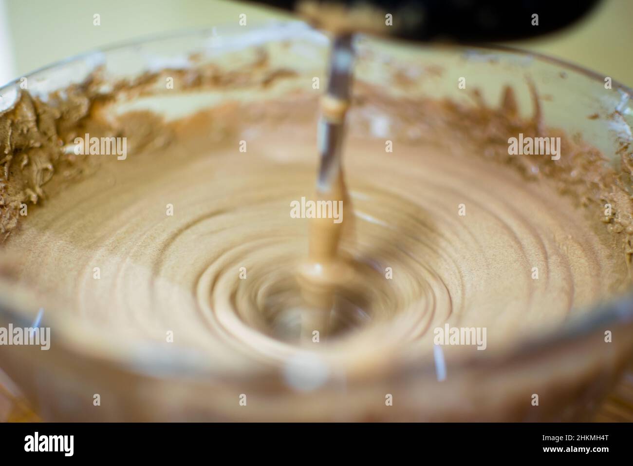 Making of ice cream by blending cocoa powder with cream. Blending the