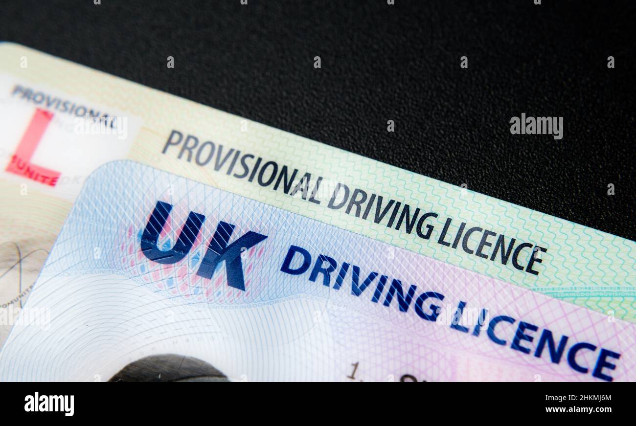 UK Driving Licence. Provisional and Full licence cards isolated on dark background. Macro. Selective focus. Stafford, United Kingdom, January 30, 2022 Stock Photo