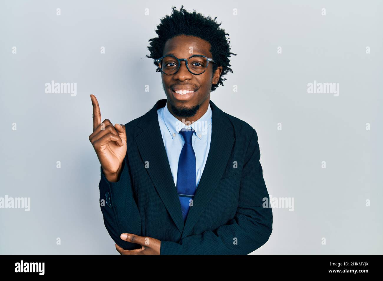Young african american man wearing business suit smiling happy pointing ...