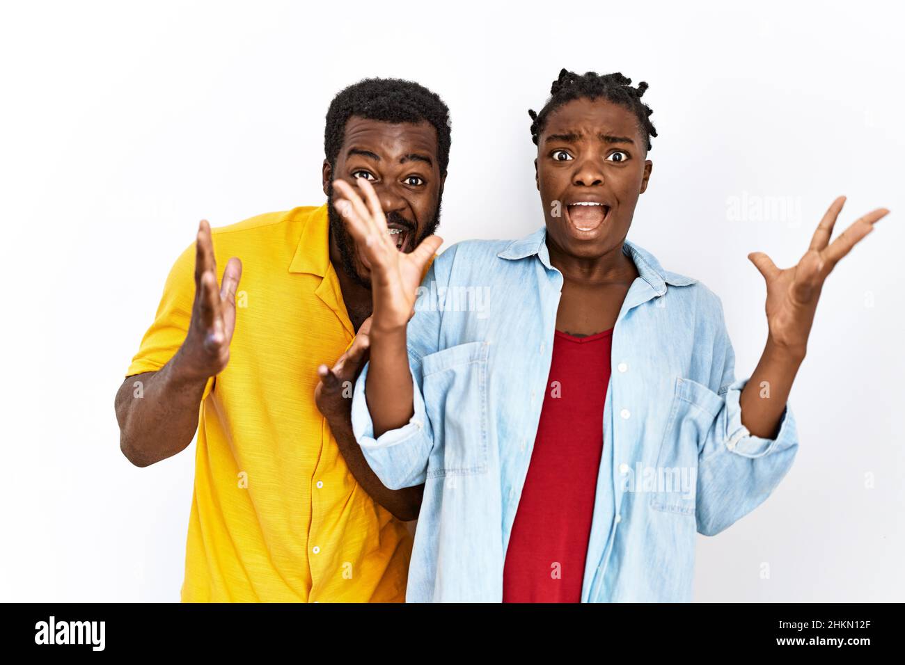 Young african american couple wearing casual clothes celebrating crazy ...