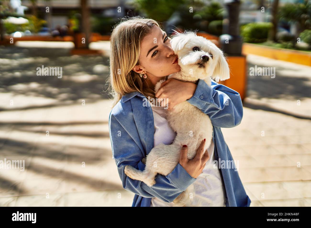 Premium Photo  A little girl kisses and hugs her jack russell terrier dog  in the park love between the owner and the dog a child is holding a dog in  his