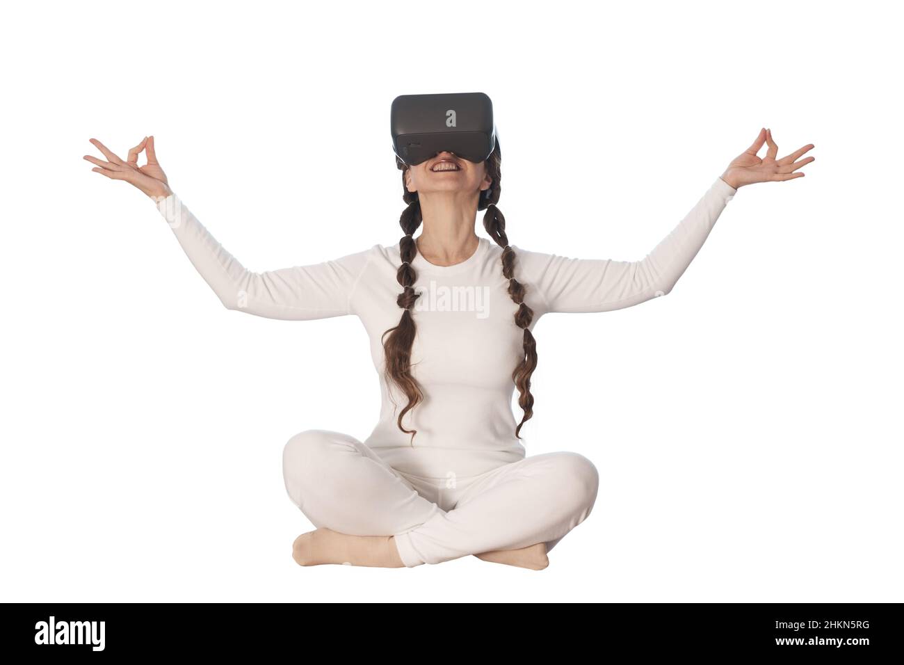 A woman does yoga with virtual reality glasses. She takes various yoga