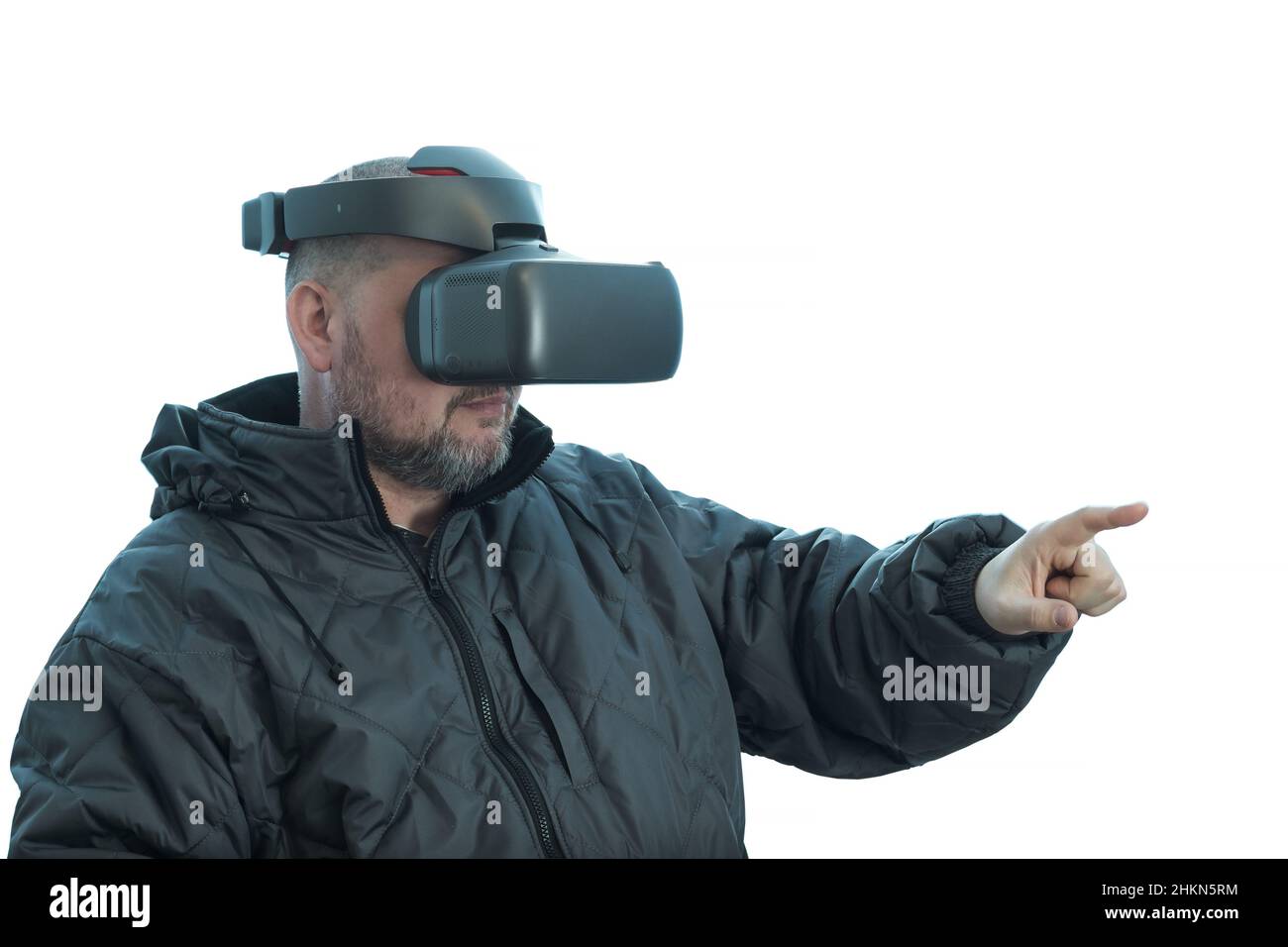 A man wearing vr glasses points his finger forward. Stock Photo