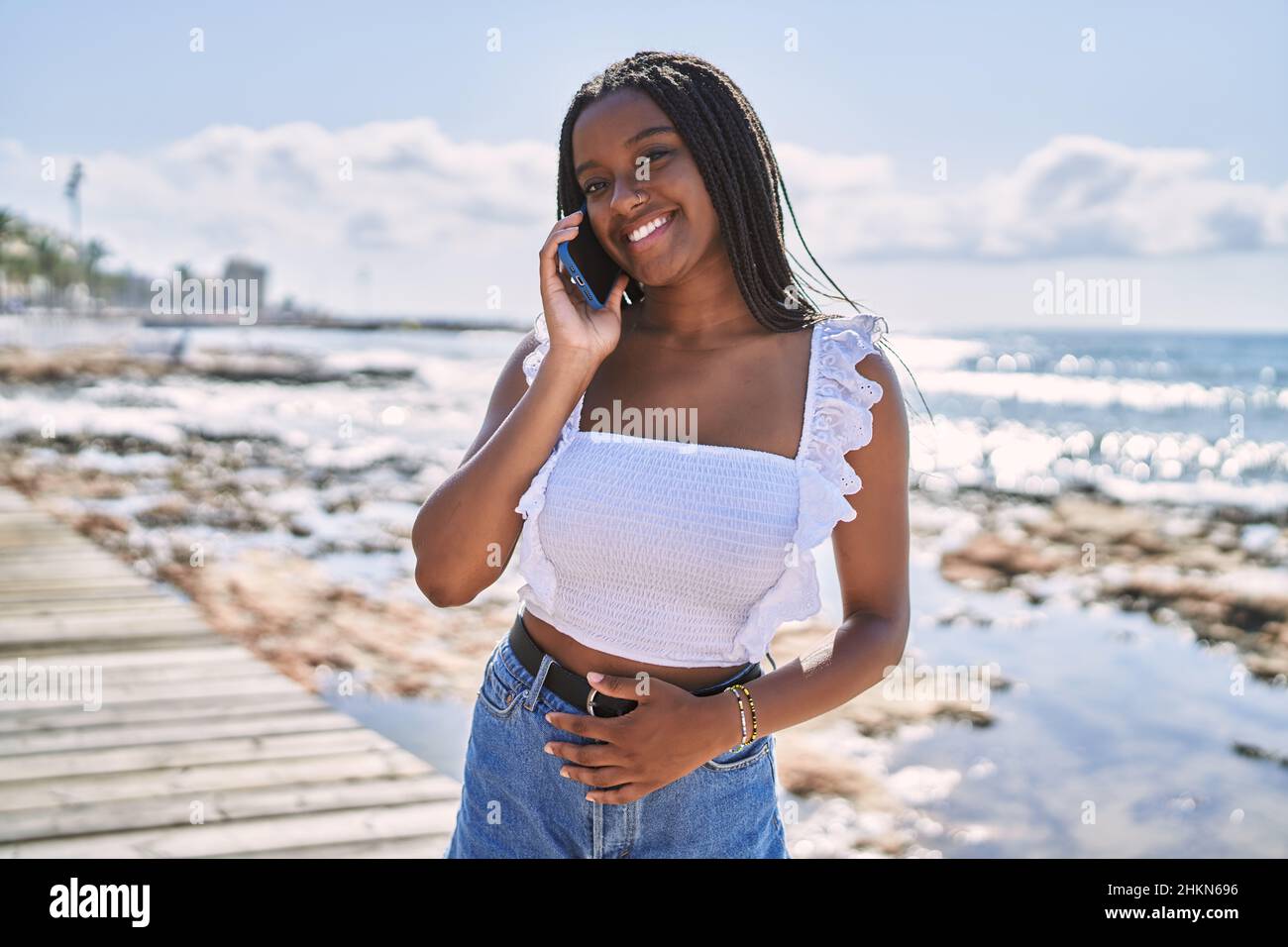 Young african american girl smiling happy talking on the smartphone at ...