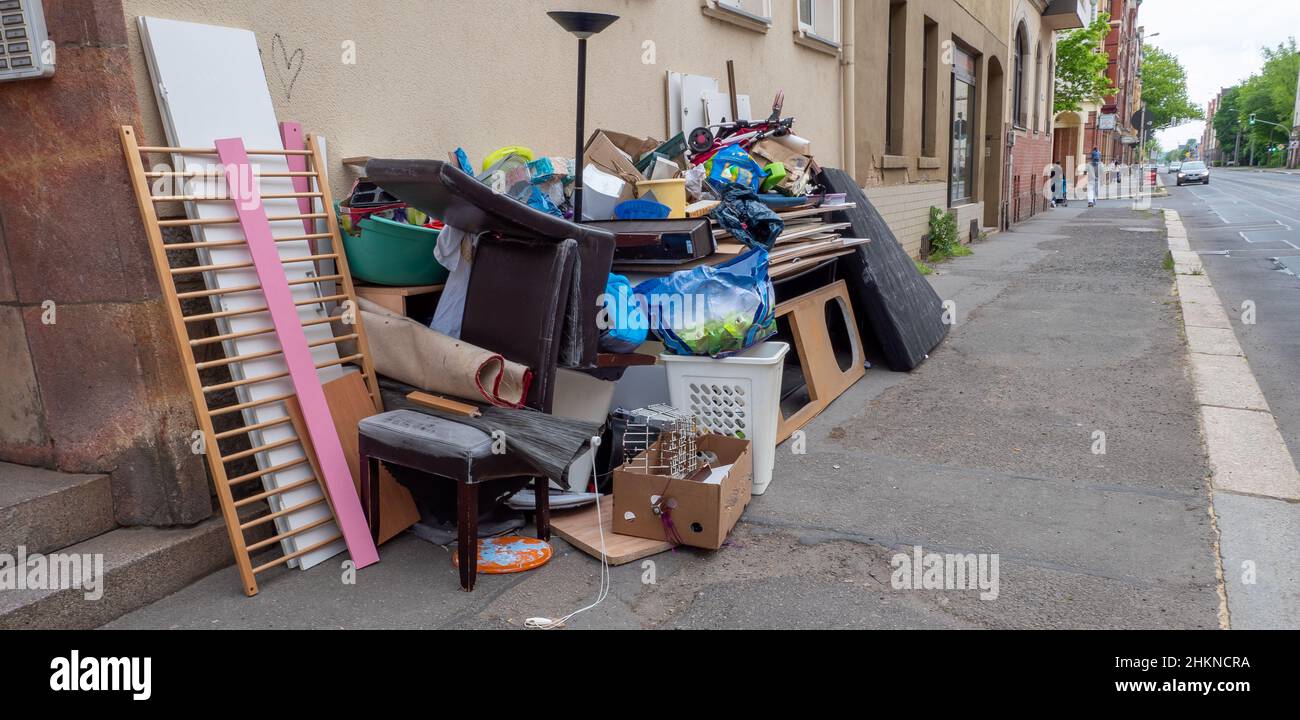 Bulky waste is in front of a house on the street Stock Photo
