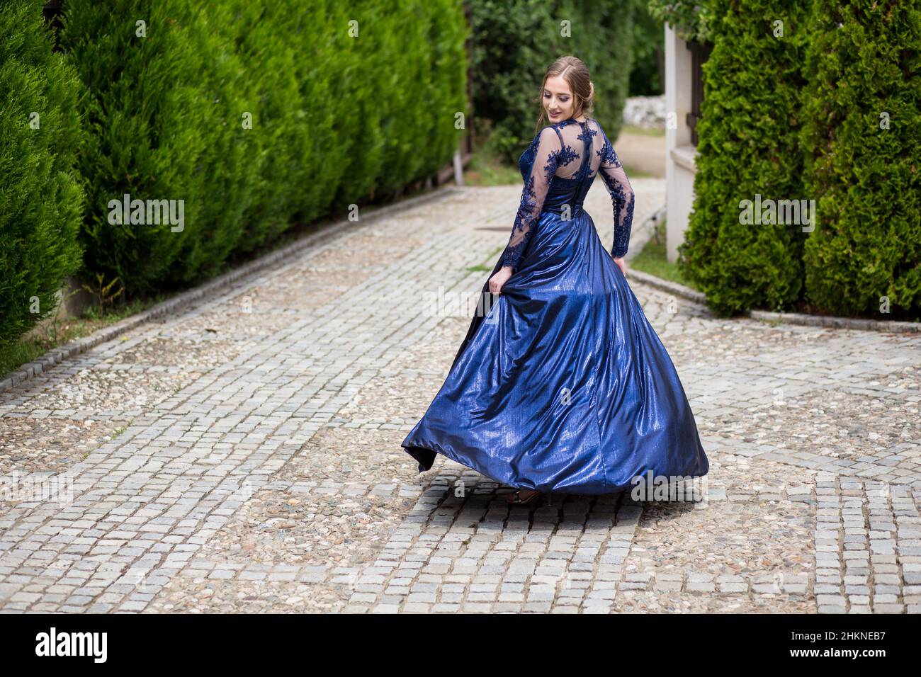 Beautiful girl in glamorous ultramarine dress. Ready for her prom night. Stock Photo