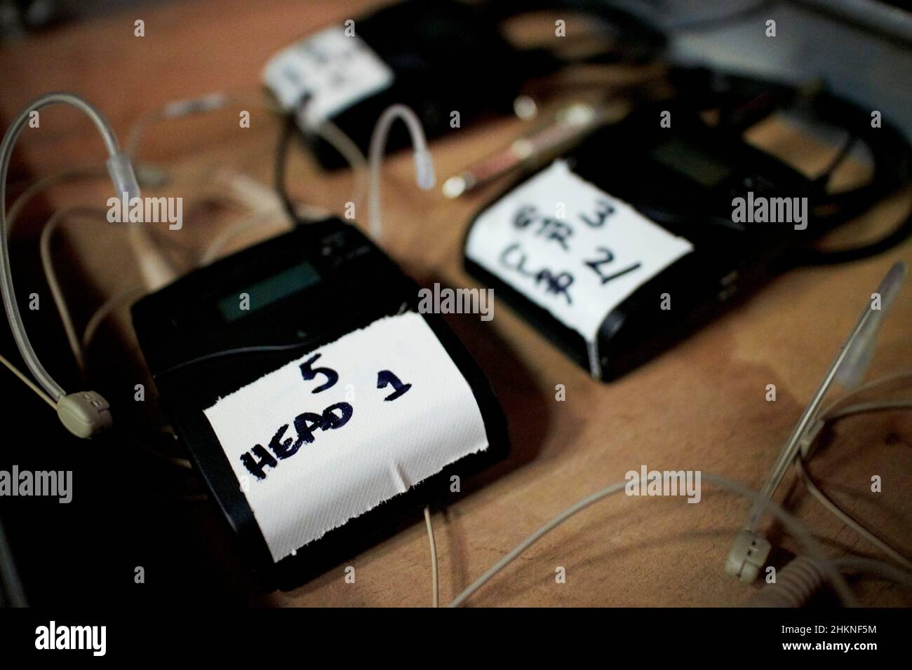radio mics and earpieces ready backstage before a production Stock Photo