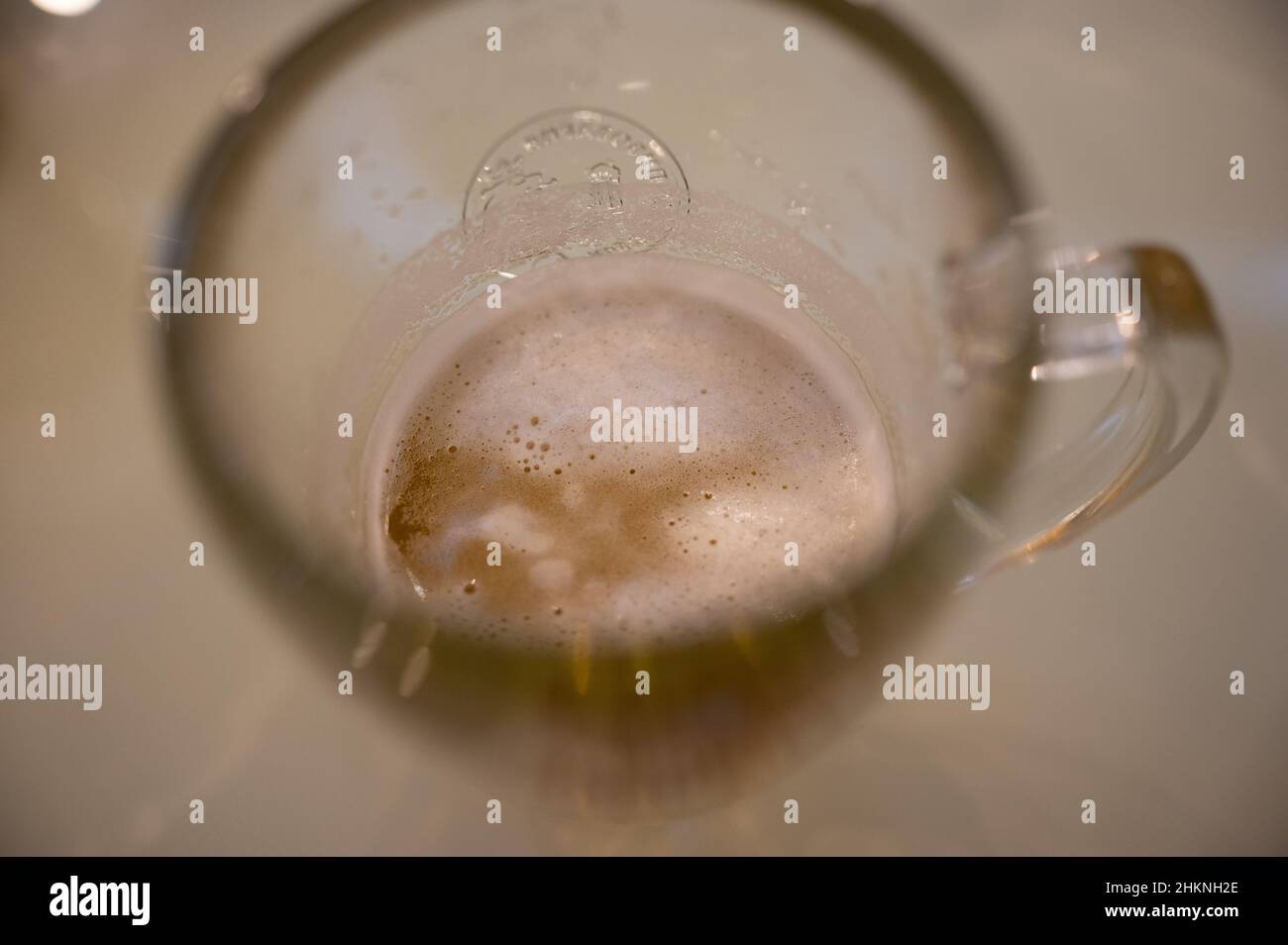 A top view of a nearly empty mug of frothy beer. Stock Photo