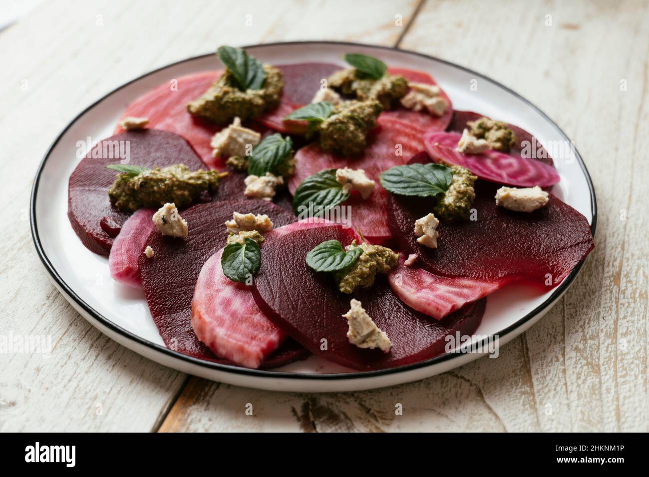 Home made beet antipasto with a basil pesto and vegan feta. Stock Photo