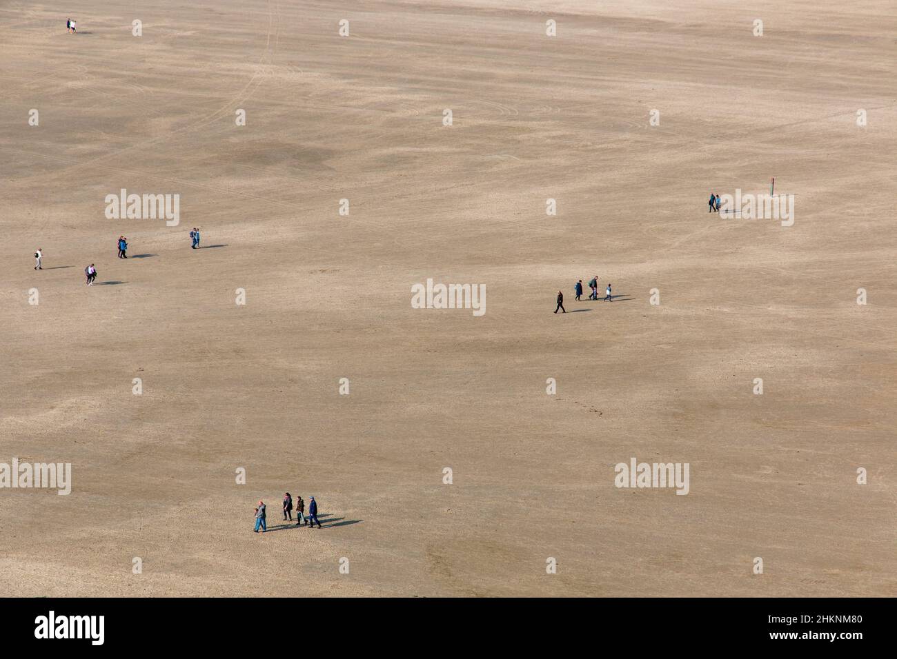 A stretch of beach with people walking in the Netherlands Stock Photo ...