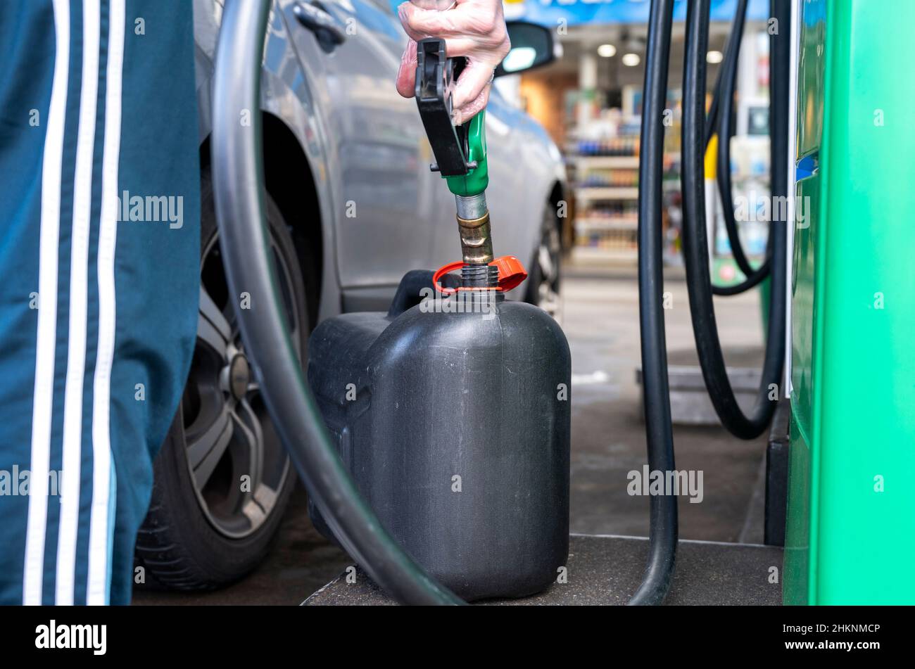 Slubice, Poland. 05th Feb, 2022. A man fills up gasoline into a canister at a gas station. A reduction in VAT on food and fuel from 23 to 8 percent means that filling up with gas in Poland is significantly cheaper than in Germany. Credit: Christophe Gateau/dpa/Alamy Live News Stock Photo