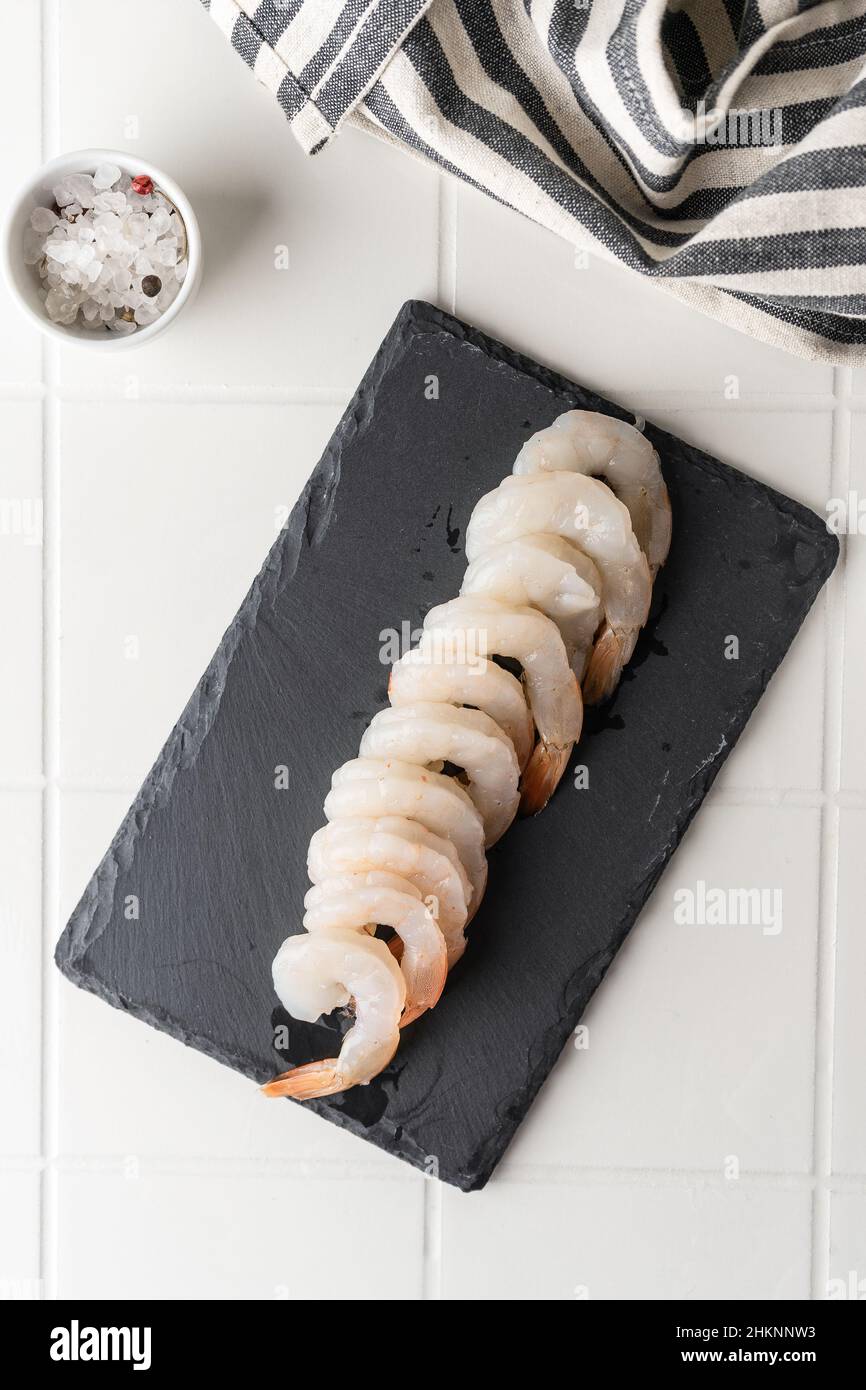Thawed peeled shrimp, seafood, delicacy. on a white background, in a ...