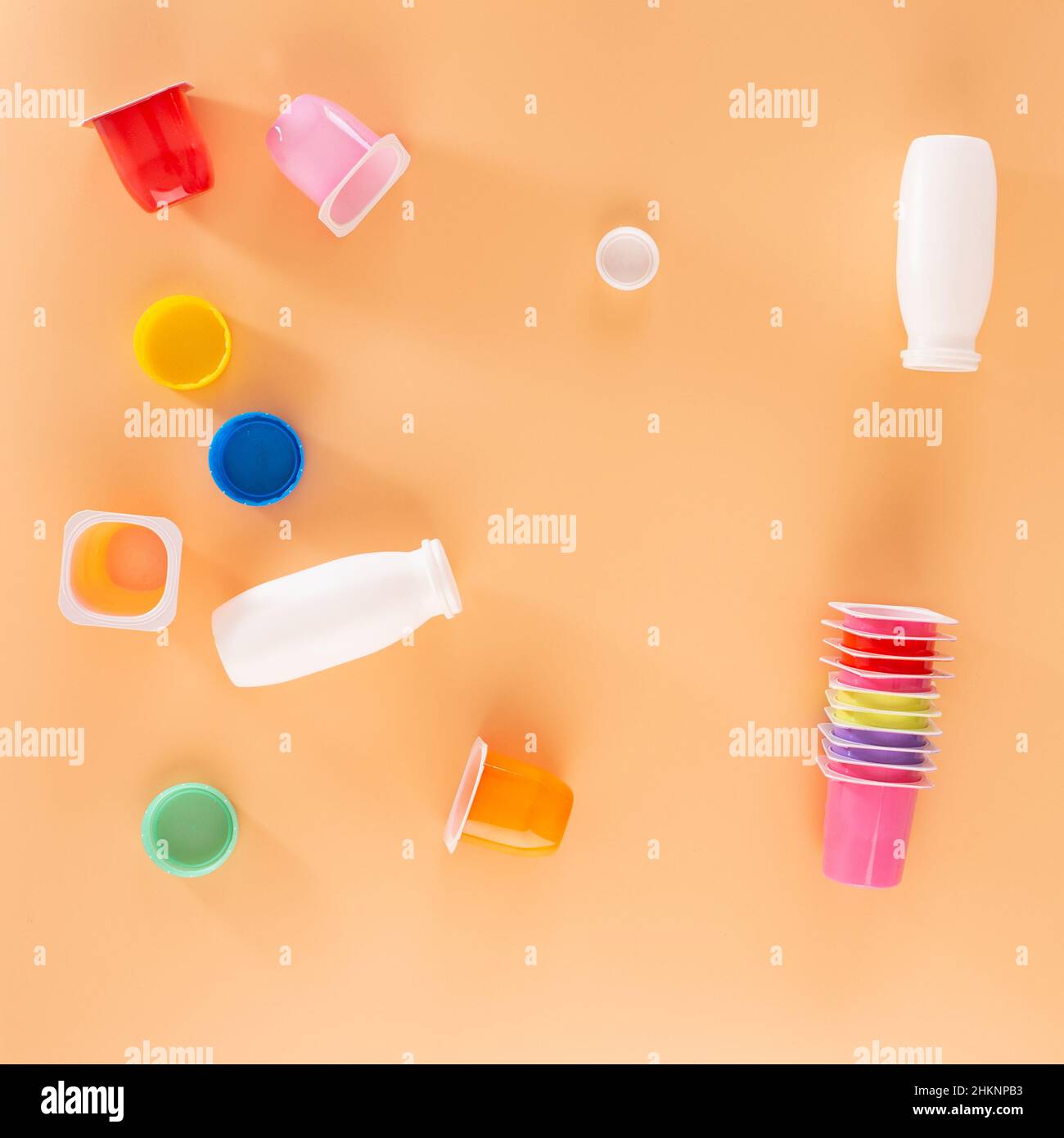 a set of multicolor packaging yogurt jars, empty plastic cups, top