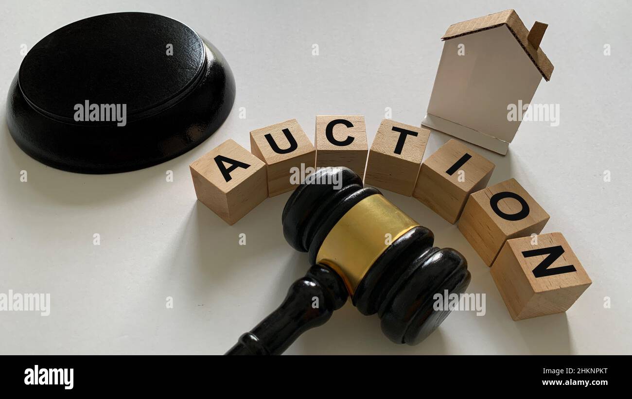 Auction text on wooden blocks with mini house and gavel background. Property concept. Stock Photo