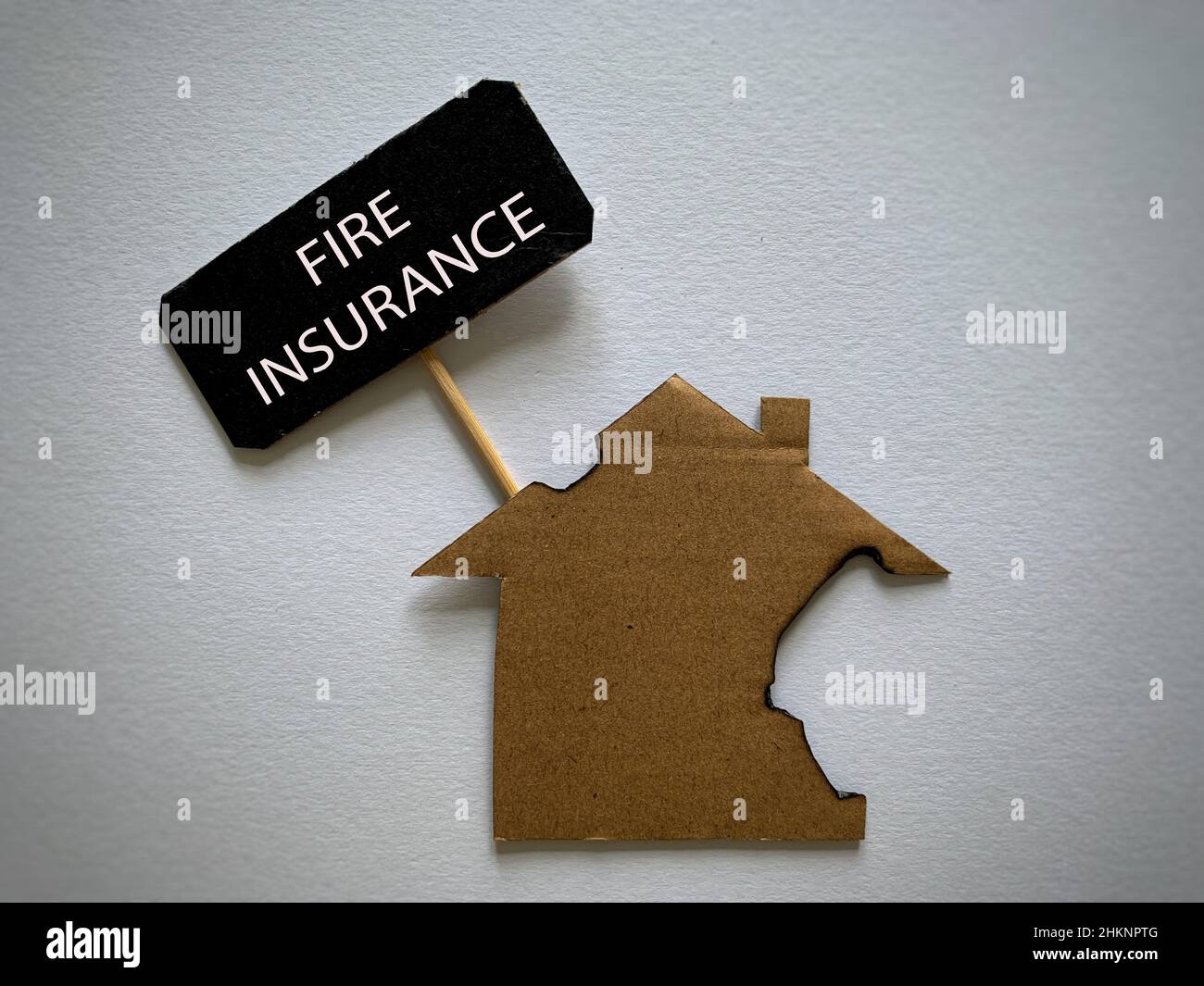 Fire insurance text with burnt model house background. Insurance ...