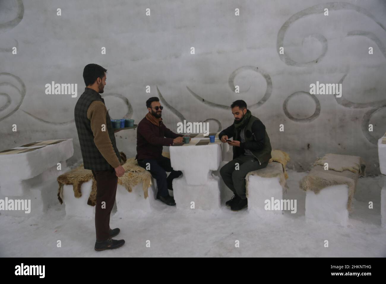 Srinagar, India. 05th Feb, 2022. Visitors sit and have drinks inside Asia's biggest Igloo Cafe made of snow in Gulmarg. The Igloo Cafe is approximately 37.5 feet tall and 45 feet round and can accommodate fifteen tables and around 60 guests. The Igloo Cafe offers tables made of ice and snow, with hot dishes served to visitors (Photo by Sajad Hameed/Pacific Press) Credit: Pacific Press Media Production Corp./Alamy Live News Stock Photo