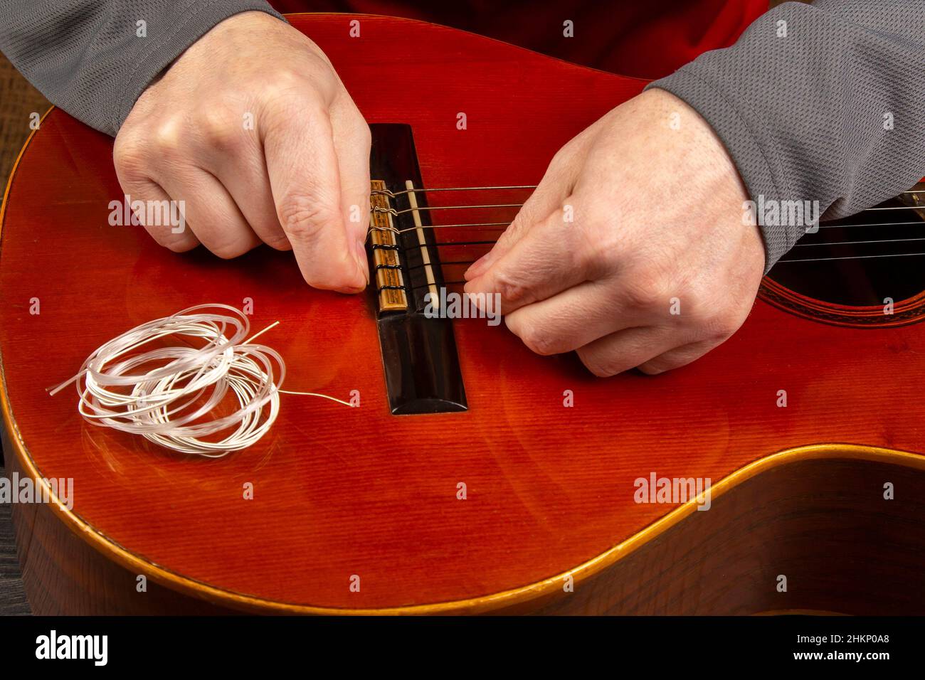 Changing nylon strings on a sixstring classical guitar. instruction