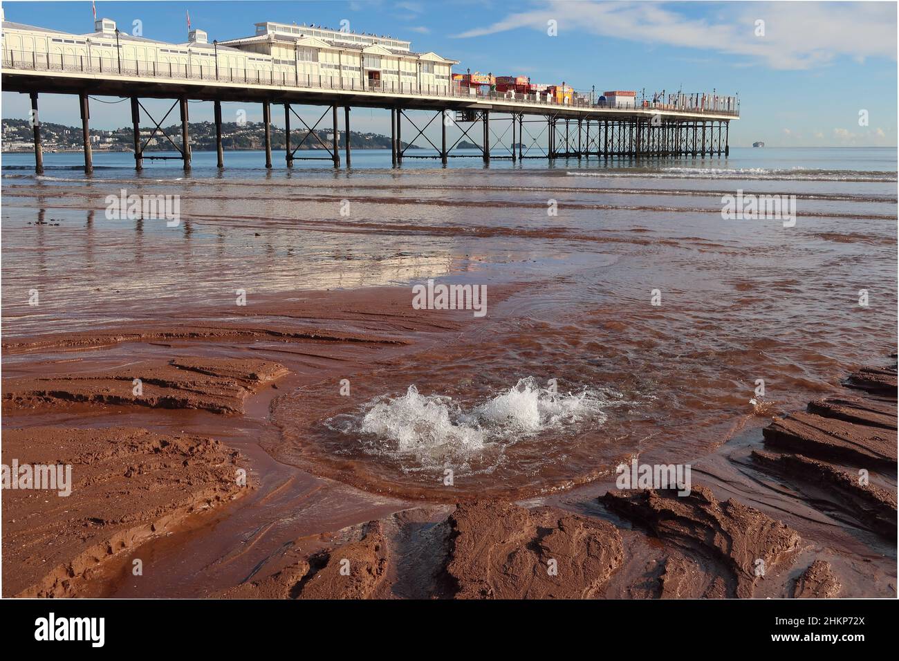 Fresh water bubbling up from an underground stream on Paignton beach at ...