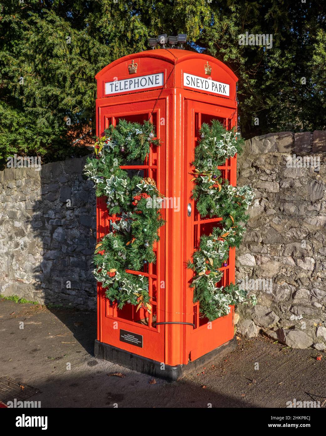 K6 telephone box in Sneyd Park Bristol UK at Christmas disused as a telephone service but preserved by the local community as a seasonal planter Stock Photo