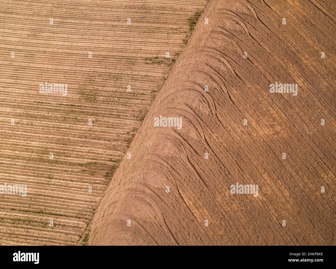 Pattern of repeating wheel tread marks on a plowed field. Stock Photo