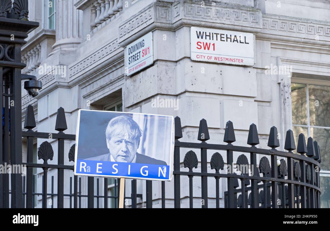 A protest sign outside the gates of Downing Street with a picture of Boris Johnson with the word Resign below. Focus on sign. London - 5th Feb 2022 Stock Photo