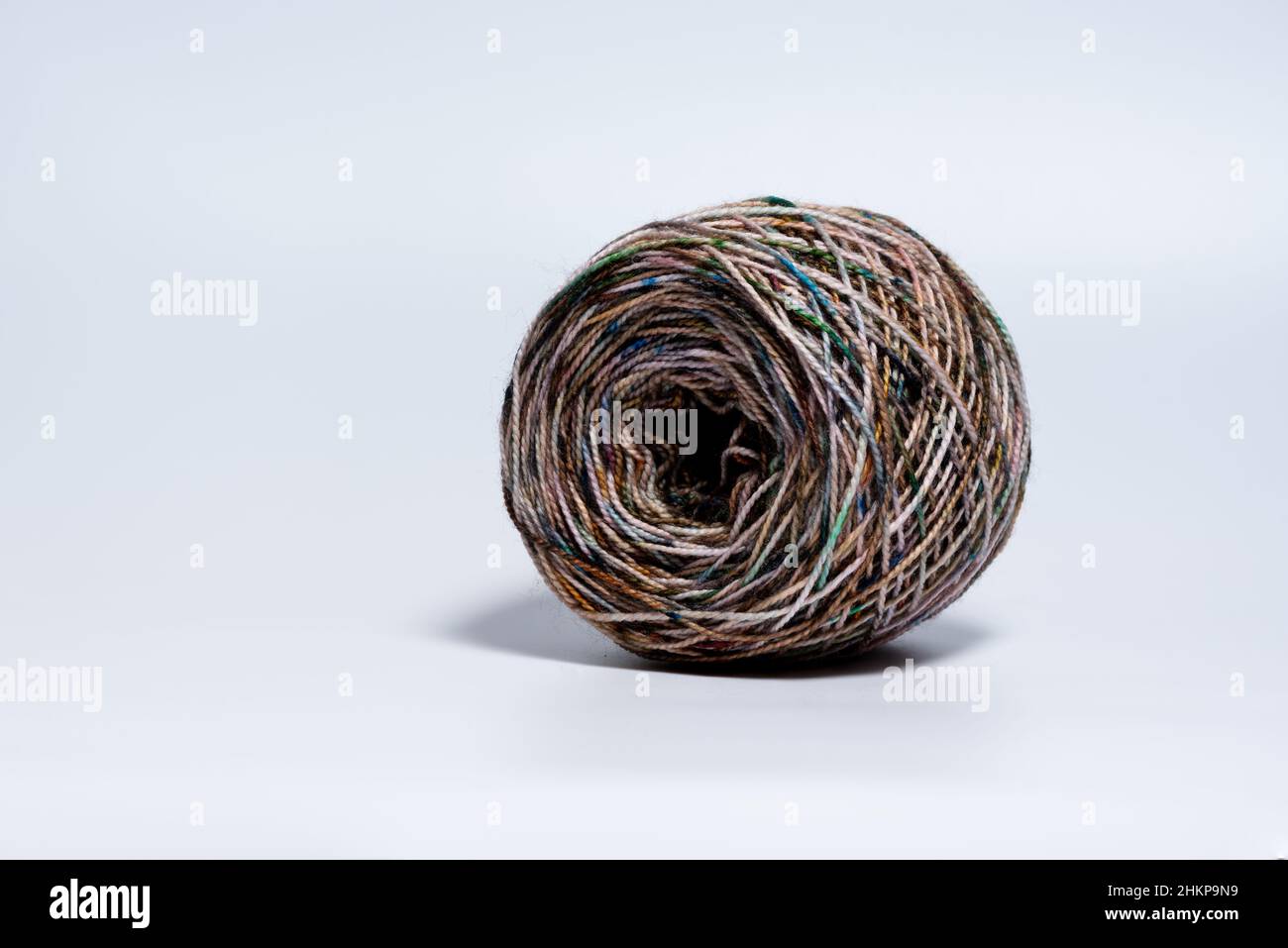 Single skein ball of yarn with variegated colors on white background Stock Photo