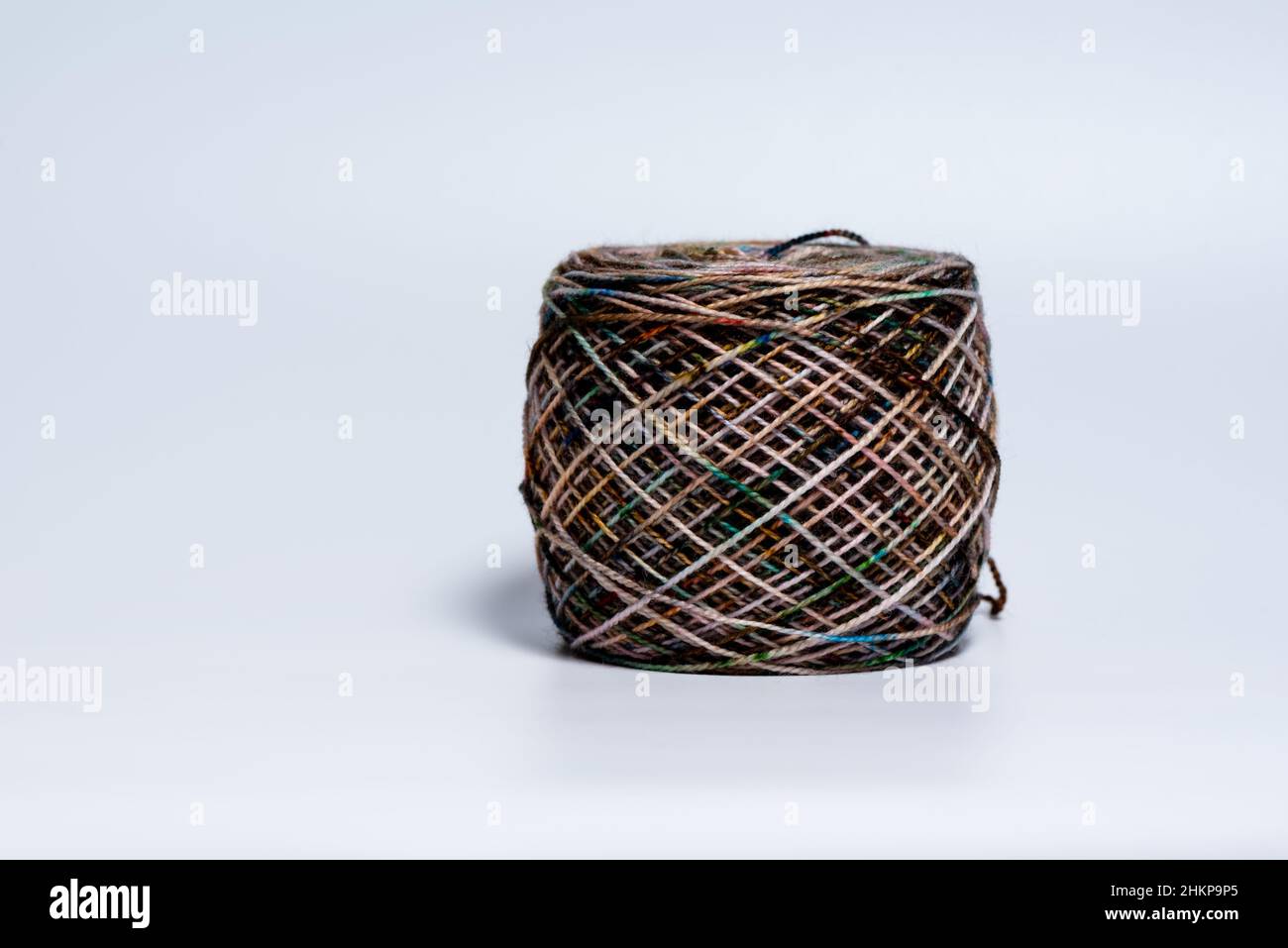 Single skein ball of yarn with variegated colors on white background Stock Photo